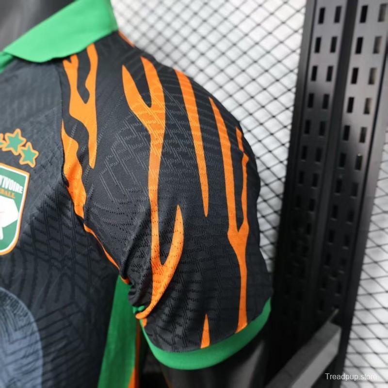 Player Version 2025 Ivory Coast Black with Elephant Graphic and Orange Stripes Jersey